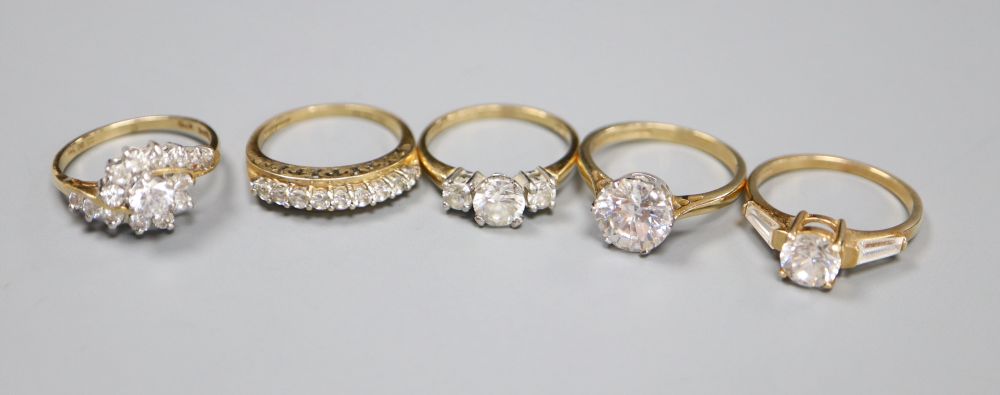 Five assorted modern 14ct gold and CZ set dress rings, gross 13 grams.
